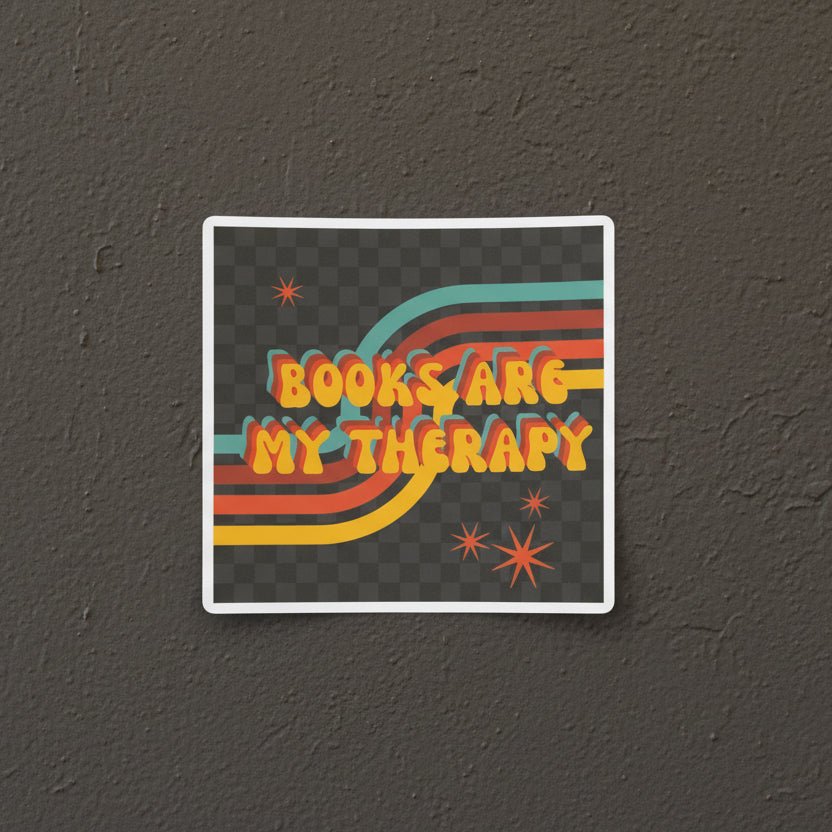 Sticker with 'Books are my therapy' text on a gray background