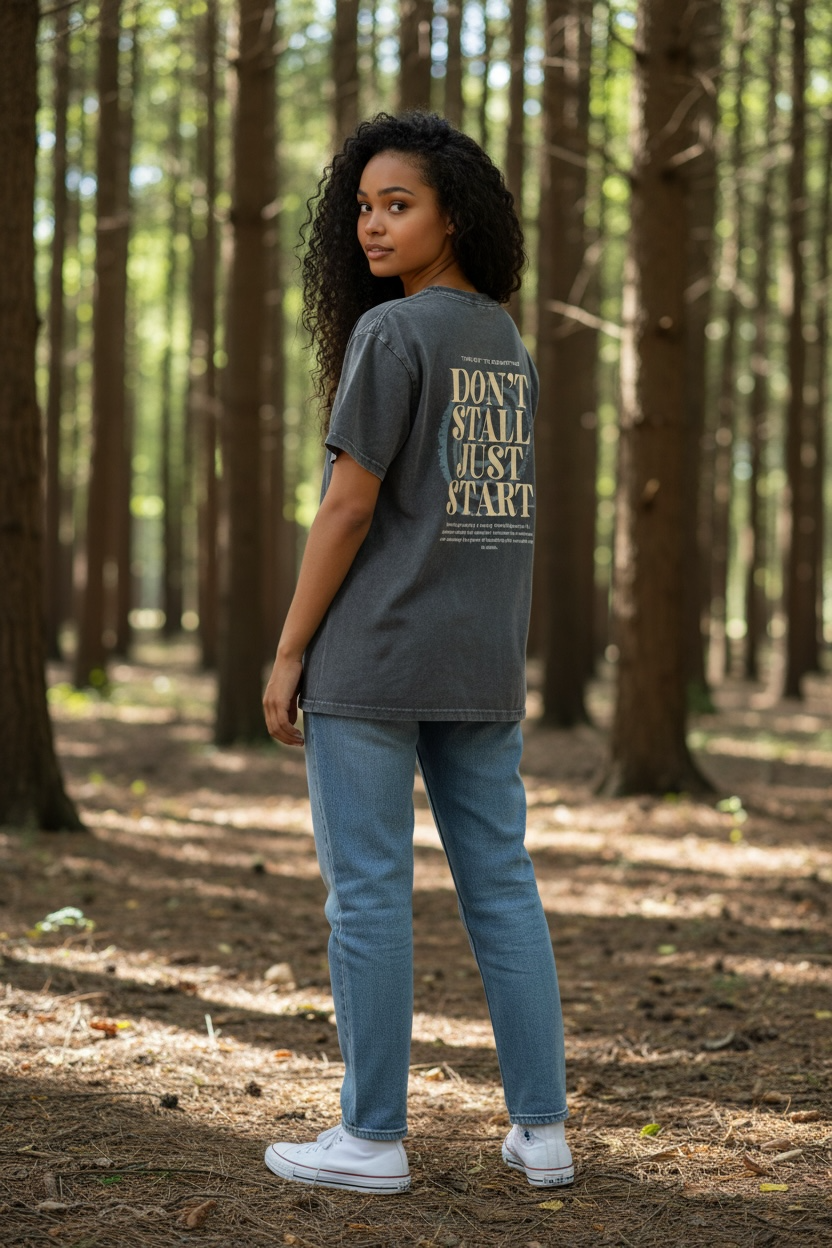 Person wearing a t-shirt with text in a forest