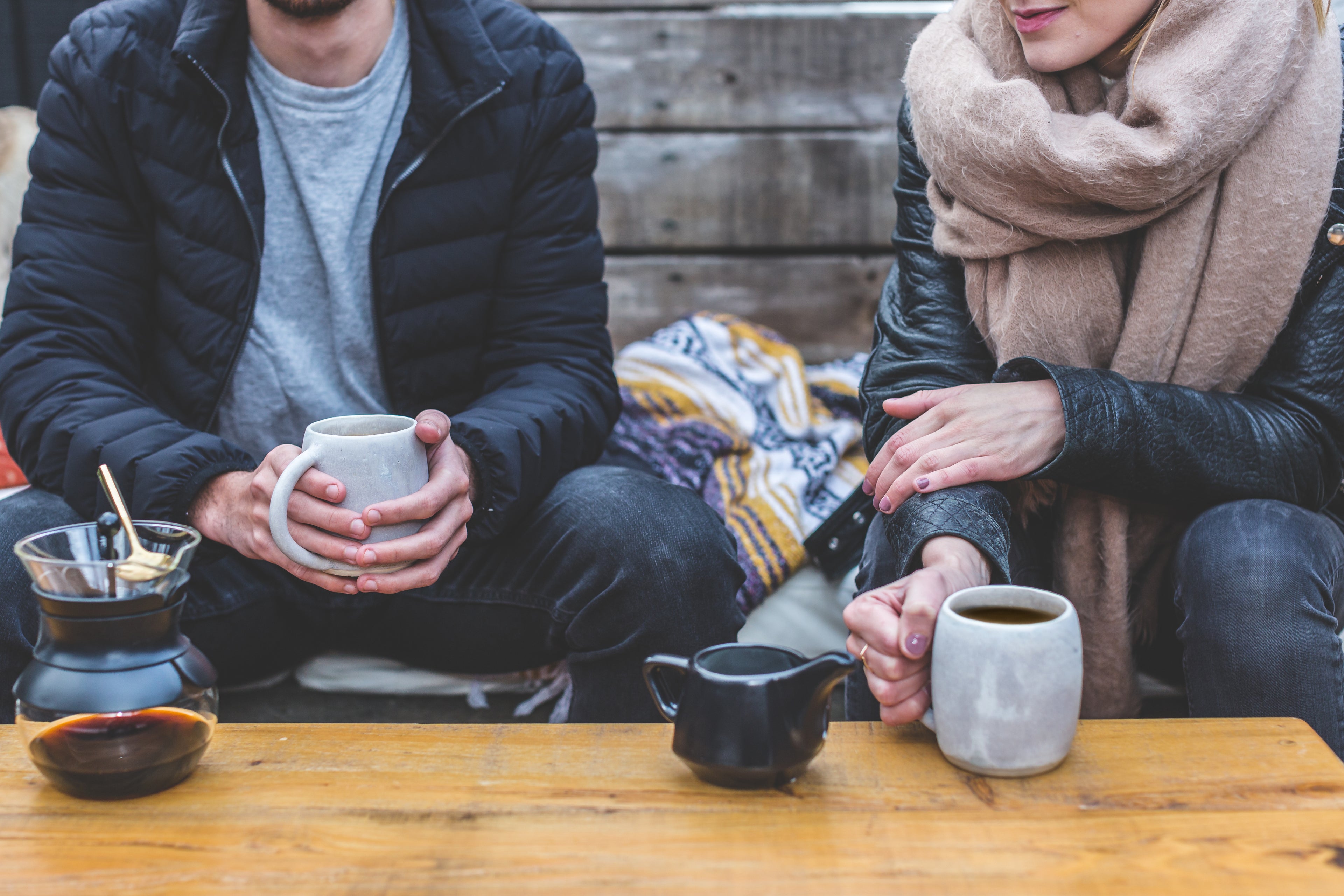 Friends sitting down drinking some coffee.