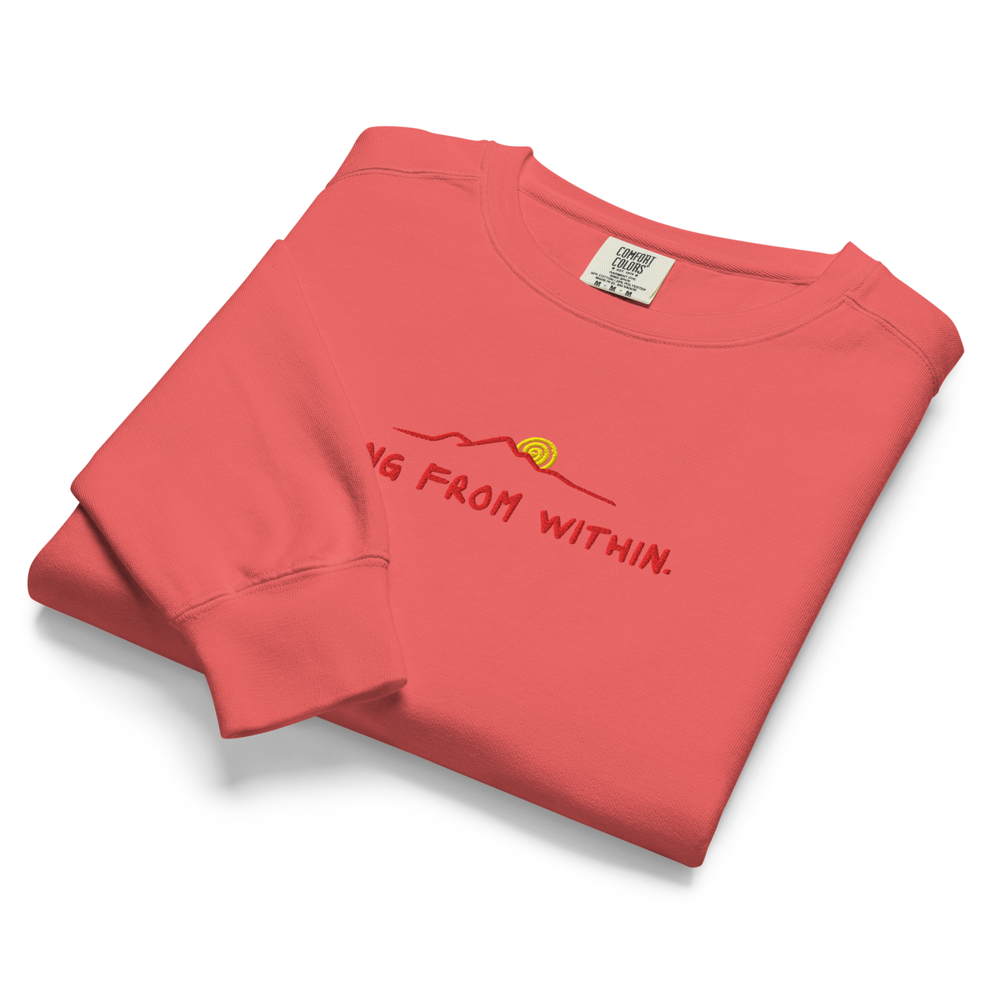 A folded bright red Crewneck that says “Rising From Within” with a mountain ridge design.